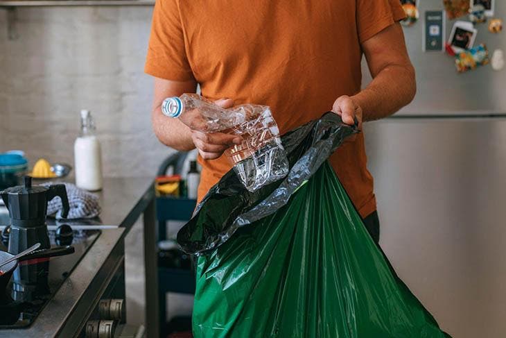 Jeter une bouteille dans la poubelle