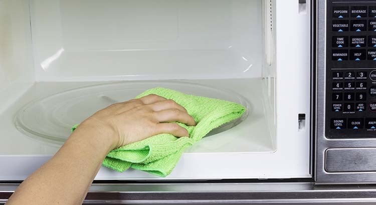 Bol d'eau et de vinaigre chauffant dans un micro-ondes