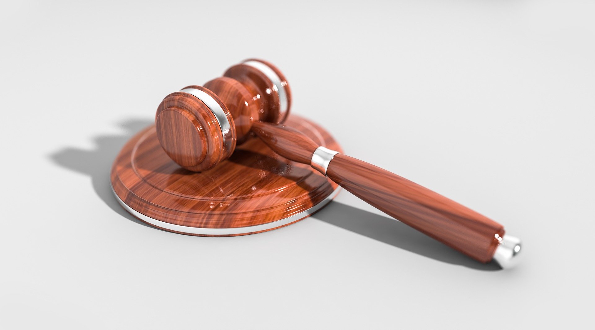 Marteau de juge posé sur un bureau en bois, symbole de la justice